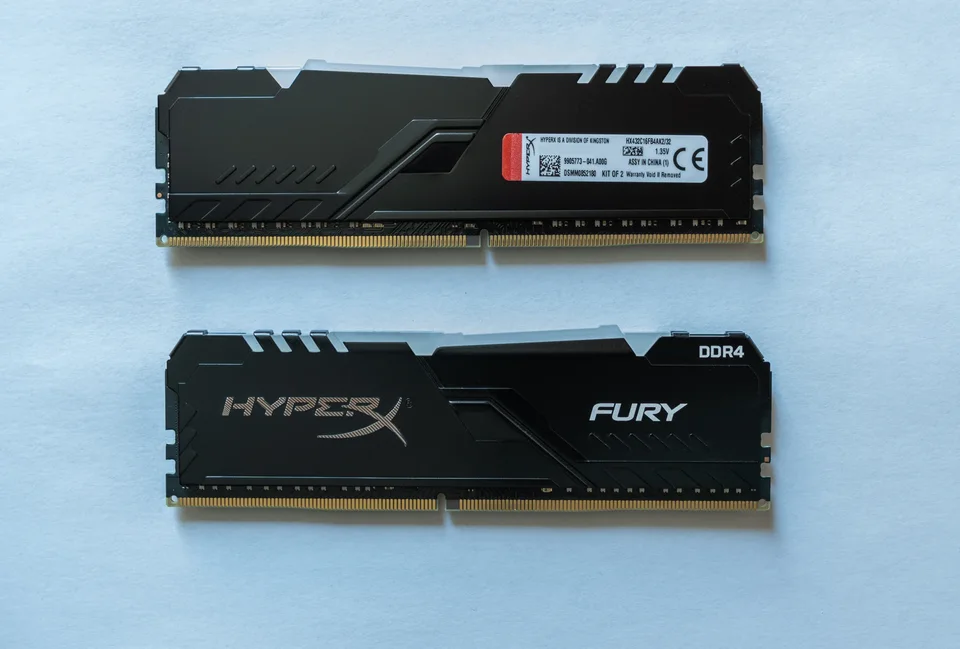 Two black HyperX Fury DDR4 desktop memory modules from a 32GB kit, with the product label visible on one module