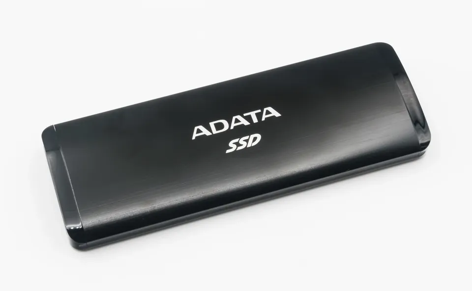 Black ADATA Elite SE760 portable SSD on a white background.