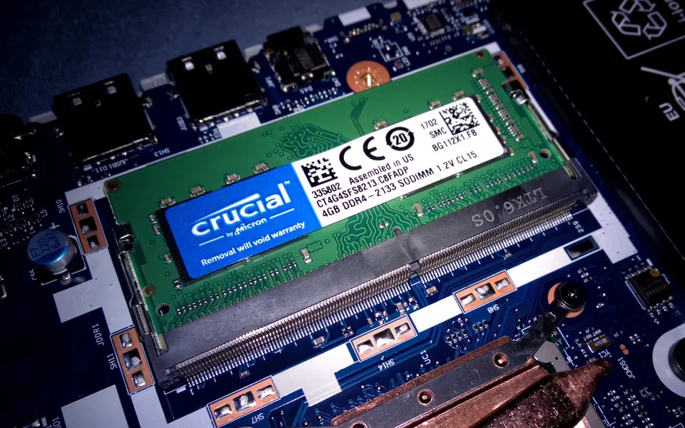 A Crucial CT4G4SFS8213 4GB DDR4-2133 SO-DIMM installed in an open laptop
