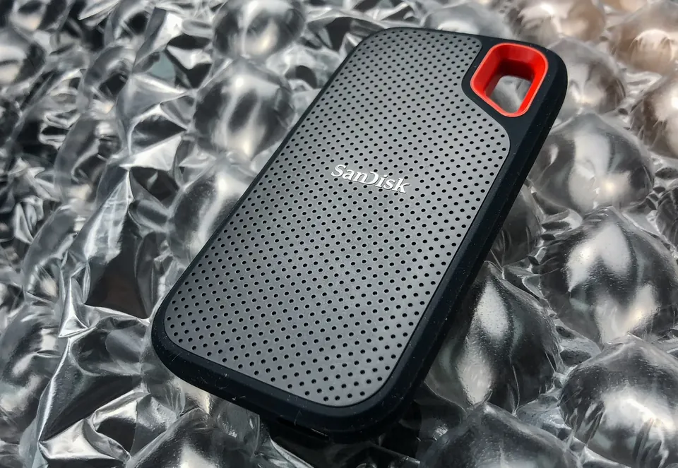 SanDisk Extreme Portable SSD with a red loop resting on bubble wrap.