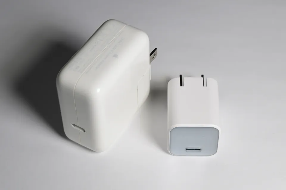Apple A2164 30W USB-C charger on the left beside a smaller Anker 511 30W USB-C charger.